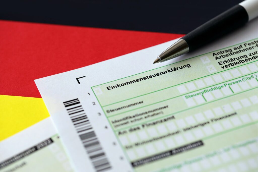German annual income tax return declaration form with pen on flag close up